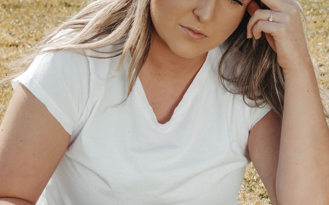 Woman holding her head in pain from a migraine headache