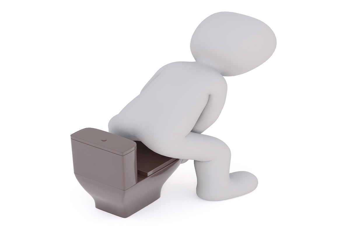 low wooden footstool positioned in front of a toilet · green kiwifruit halved on a plate beside a bowl of prunes · person lying on back drawing both knees towards the chest on a yoga mat
